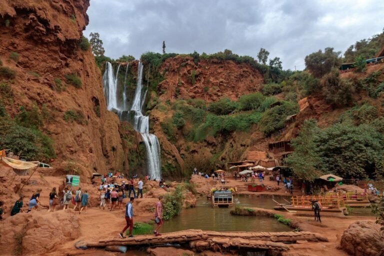 people walking and standing near waterfalls